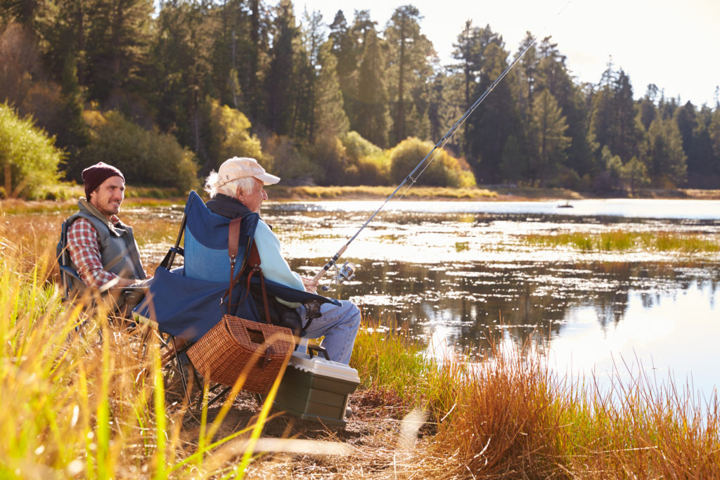 a son and his elderly father enjoying quality time together fishing at Big Bear Lake