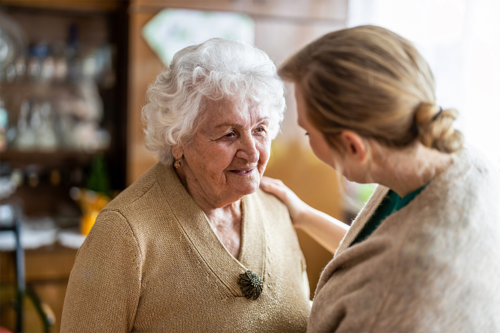 An in-home care representative visiting a client with dementia to assess the potential need for more in-home care.