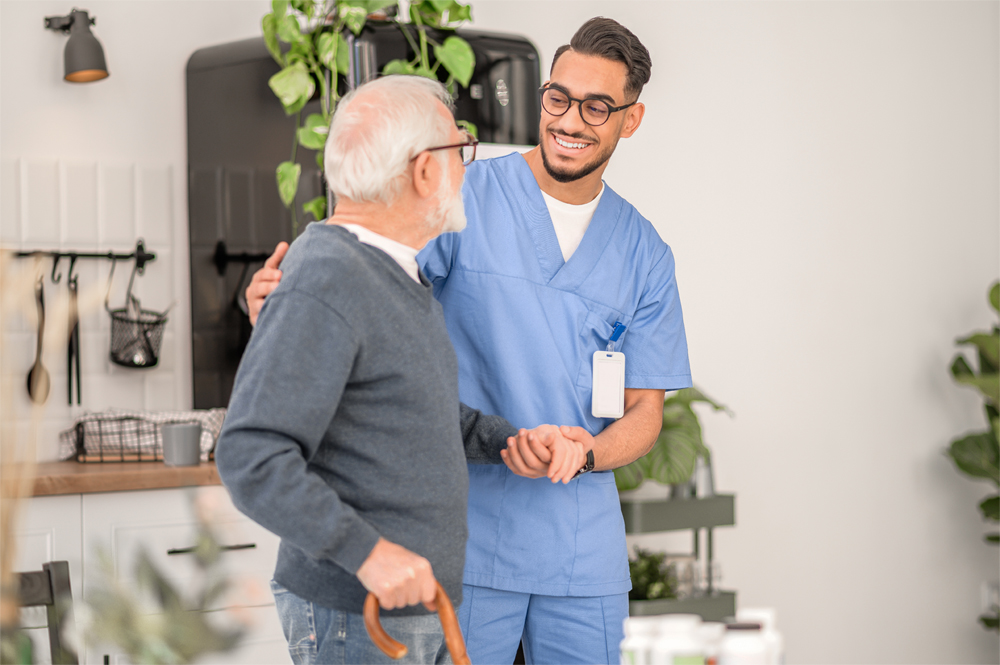 An in-home caregiver assisting a senior on a walk.