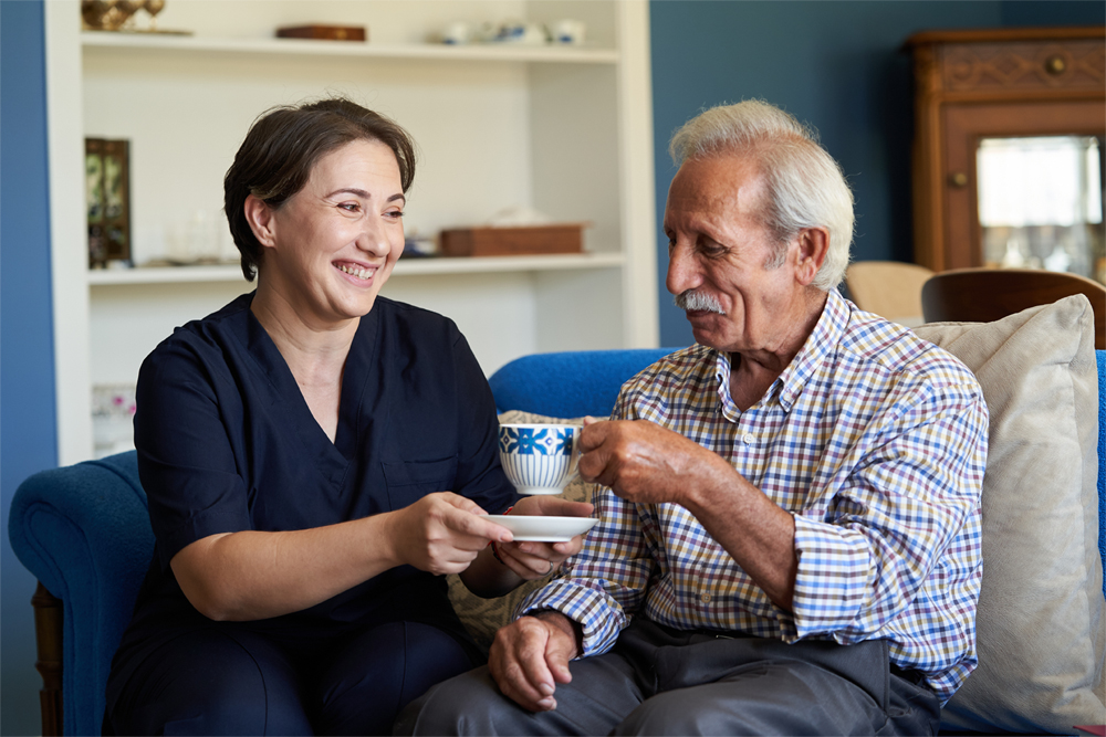 A senior man receives in-home care.