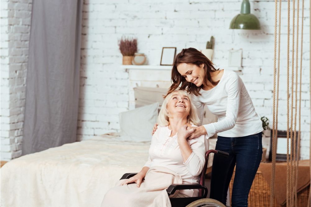 A woman taking care of her elderly parent in a wheelchair at home.