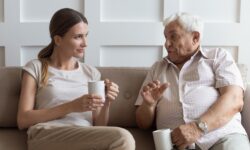 After learning more about effective communication with the elderly, a daughter patiently listens to her father.