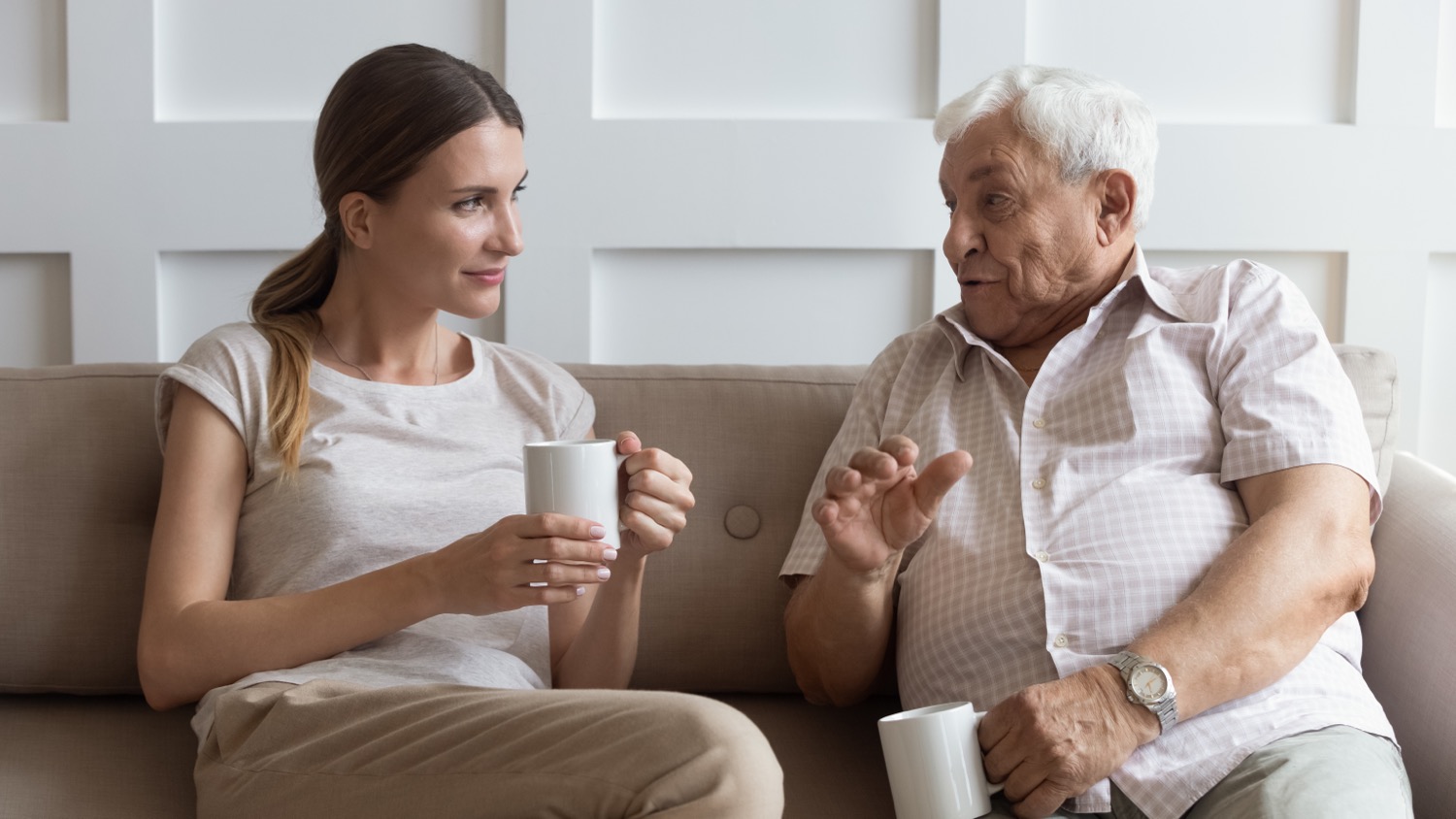 After learning more about effective communication with the elderly, a daughter patiently listens to her father.