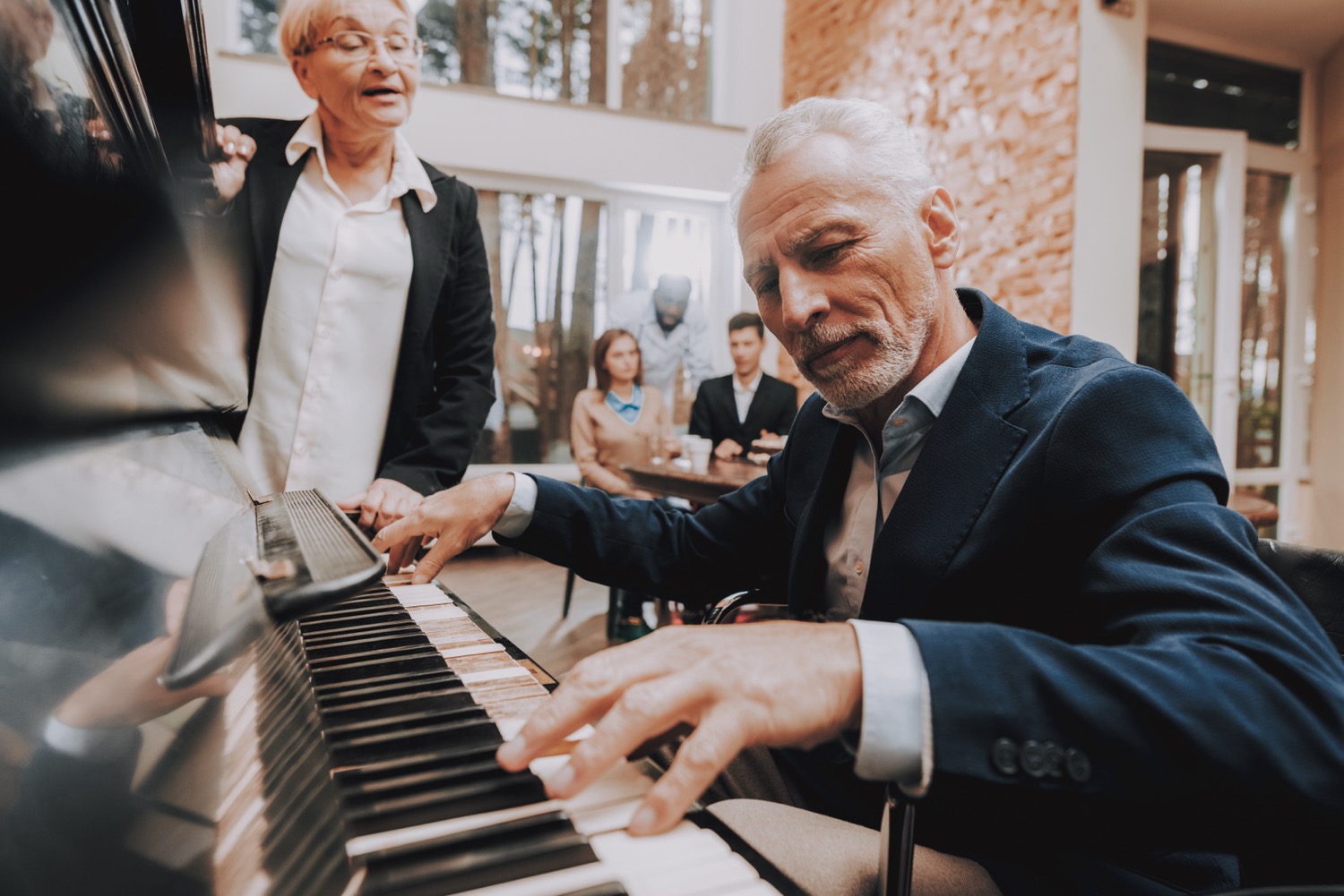 As part of his music therapy and Alzheimer’s care plan, an older gentleman plays the piano regularly for his fellow nursing home residents.