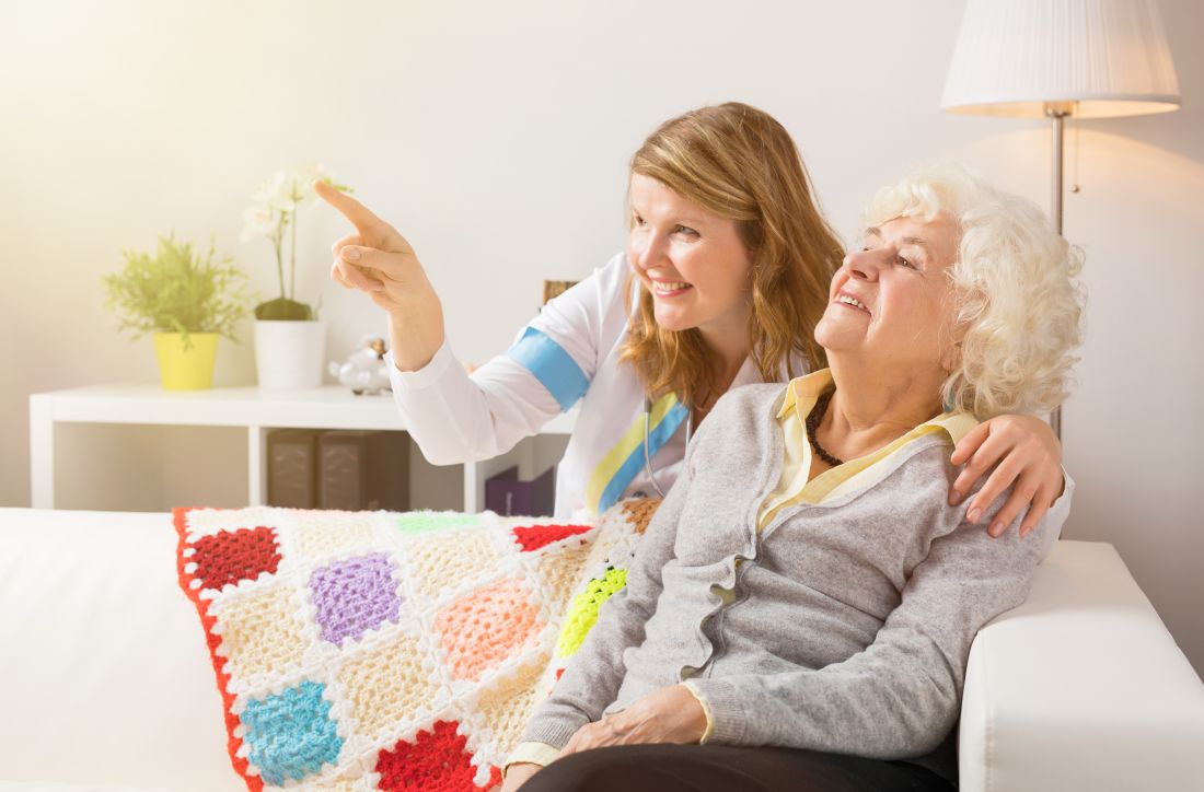 Senior woman and caregiver looking at something